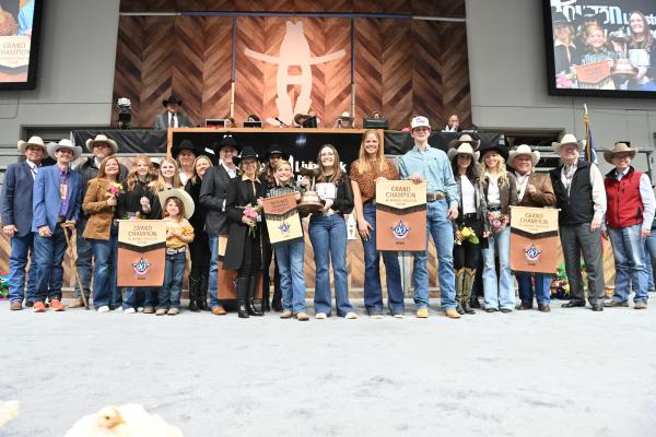 Kenna Schram, center holding trophy, represented Sealy FFA as the Houston Rodeo’s Broiler Grand Champion after her project sold for $200,000 last Friday, March 11 at the 2022 Junior Market Poultry Show. RODEOHOUSTON