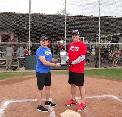 Bellville Police Chief Jason Smalley and Bellville Volunteer Fire President Jason Greene share the trophy for a moment after the Austin County First Responder exhibition game that preceded the annual Guns N’ Hoses Softball Tournament at the Bellville Little League Fields Saturday afternoon. (Contributed photo)