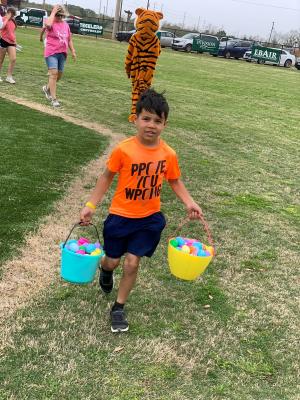 Abraham Rosas hauls his winnings after the 10th annual Easter Eggstravaganza April 10 at B&PW Park in Sealy. COURTESY PHOTO