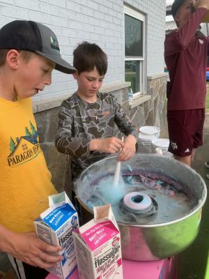 Wyatt Blanks and Cole Whatley operate the cotton candy machine as part of the Easter Eggstravaganza activities at Sealy’s B&PW Park April 10. COURTESY PHOTO