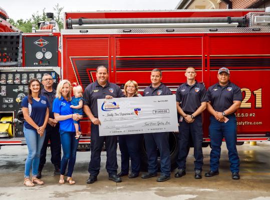 Texas Premier Sporting Arms presented a donation check to the Sealy Fire Department April 15 from funds raised at the first annual Crawfish and Clays Sporting Tournament. Pictured from left to right are Kelsie Krenek, Randy Ostwald, Rebecca Morone with Madison Grace, Chief Kenny Willingham, Judy Zapalac, Steve Noack, Kevin Kramr and Jeramie Casiano. CONTRIBUTED PHOTO