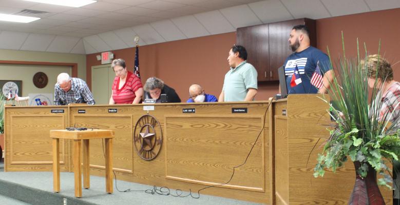 All five council members stood when Mayor Dennis Diggs asked them to identify whether they were in favor of removing the executive session from the agenda. HANS LAMMEMAN