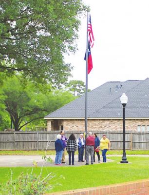 The United States and Texas flags flying outside Sealy’s Virgil and Josephine Gordon Memorial Library were donated by the Sealy American Legion Auxiliary April 19. COLE McNANNA