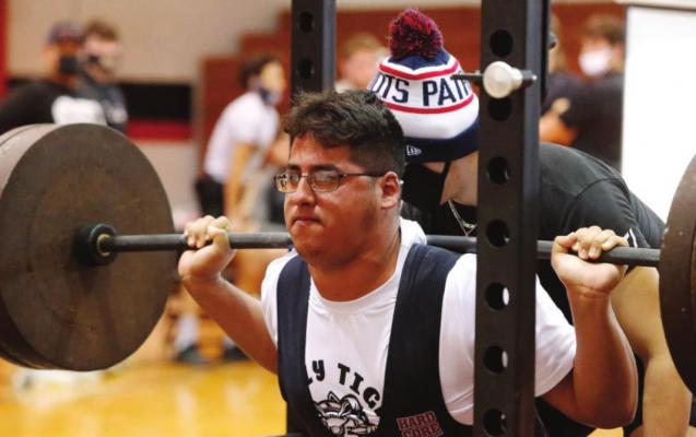 Sealy junior Yahir Alvarez executes a squat at the Brazos Boys LCQ Meet Feb. 24 in Wallis. Alvarez represented the Tigers at the Regional Championship last weekend and compiled the highest total weight lifted for the team with 1,245 pounds. COURTESY RYAN DUNSMORE/FORT BEND HERALD a at the Brazos Meet Feb. 24 in