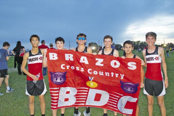 The Brazos boys’ cross-country team pose with their banner in celebration after a race during the Frio Friday Night Lights cross-country event. Left to right: Gustavo Lara, Logan Main, Wes Holub, Bryan Pedroza, Anthony Gonzales and Payton Nanez. PHOTOS BY JASON MANAGO-GRAVES