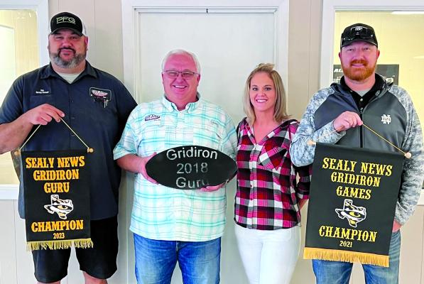 Jim Pursley, second from left, was crowned this year’s Gridiron Guru champion marking the third time he has worn the title. Pictured left to right are Nick Butler, Jim Pursley, Amanda Luksha and Shawn Brennan. COURTESY PHOTO