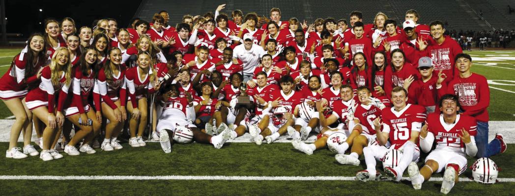 Bellville varsity players and cheerleaders pose with the regional semifinals trophy after defeating Silsbee last Friday night. COURTESY PHOTOS