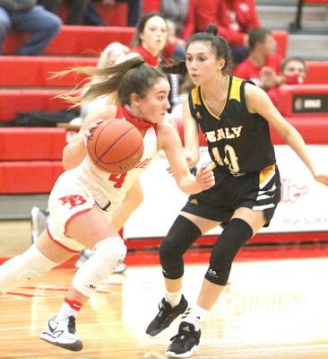 Bellville freshman Mackenzie Watson advances the ball against Sealy senior Heaven Hernandez in the district contest at home on Jan. 8. Cole McNanna