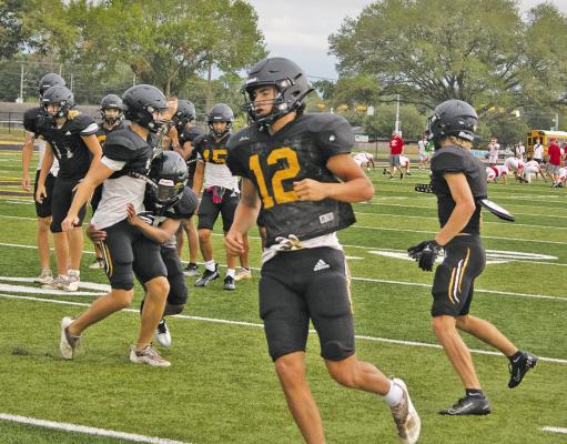 JASON MANAGO-GRAVES Sealy High School Tigers safety Mason Klotz (center) and the defensive back group go through tackling drills as they prepared to face the Columbus High School Cardinals in a home scrimmage Aug. 18.