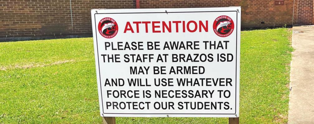 A sign in front of Brazos High School warns visitors that some staff are armed. JASON MANAGO-GRAVES