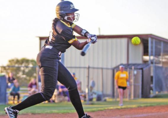 Sealy senior Ariel Gonzales connects on a pitch in the second inning of the Lady Tigers’ home district game against Royal last Thursday, April 14. Gonzales later delivered the hit that scored the winning run. COLE McNANNA