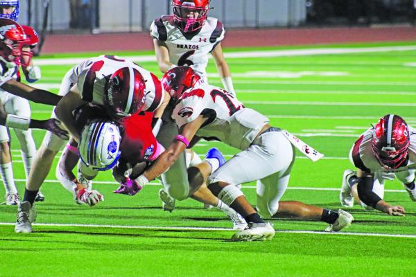 Brazos’ defense swarms a Tidehaven back during the first meeting between the two squads back in October. The two teams will meet against in the playoffs this Friday at 2 p.m. at Alvin’s Freedom Field. PHOT0 BY JIMMY GALVAN
