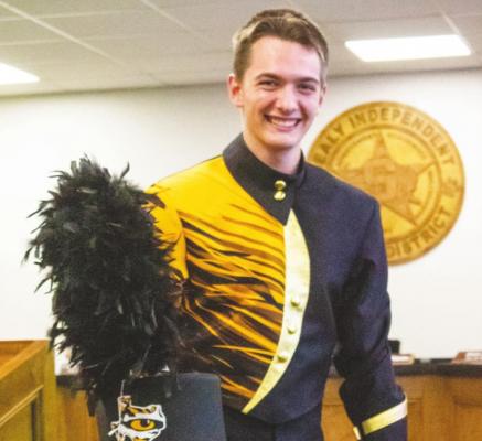 Sealy High School Drum Major Ike Konvicka shows the alternative look on the newly approved hat and jacket that are part of the new band uniforms.