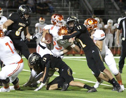 Sealy senior Lane Holley (12) teams up with Tyler Hennessey (13) to take down Orangefield  junior fullback Hunter Ashworth (22) in the Tigers' bi-district win at Huffman's Falcon Stadium. Holley joined Hennessey on the Padilla Poll second-team all-state. (Cole McNanna/Sealy News)