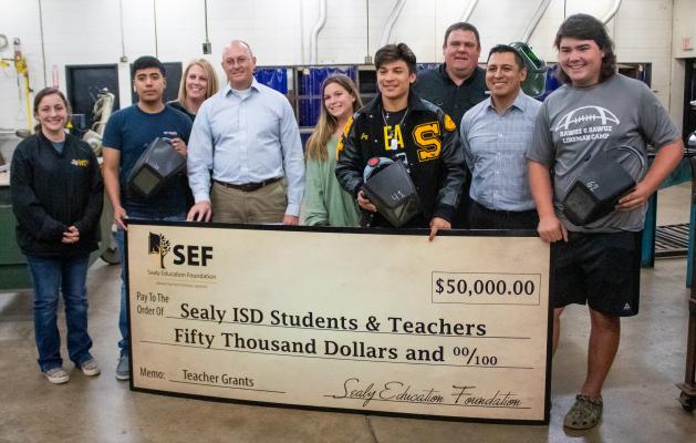 Sealy High School FFA Advisor Angela Snowden, far left, accepted a $3,600 grant for a welding machine from the Sealy Education Foundation on behalf of FFA Advisor Troy Oliver Thursday morning, March 24. COLE MCNANNA