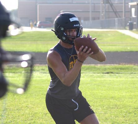 Thomas Clark looks in a pass during the first day of practice Monday morning at Sealy High School.