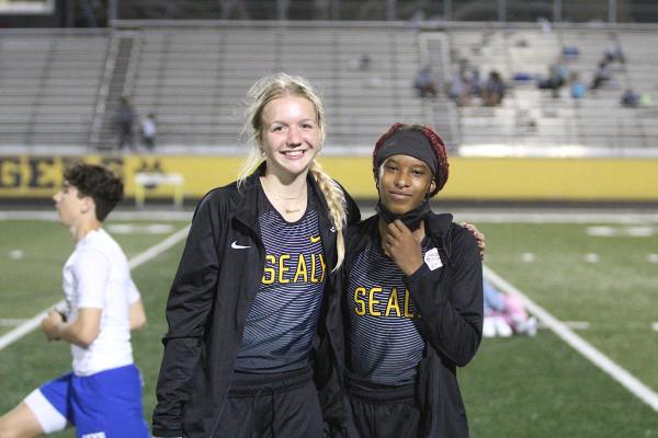 Sealy Lady Tigers Breanna Brandes and Taniah Coleman pose for a picture on Mark A. Chapman Field at the annual Sammy Dierschke Relays March 11 at T.J. Mills Stadium where the pair set school records to help Sealy win its host meet. COLE McNANNA
