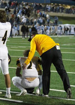 Sealy Head Football Coach Shane Mobley offers encouragement to junior quarterback D'vonne Hmielewski after the loss in the Area Championship at Waco ISD Stadium Friday night. COLE McNANNA