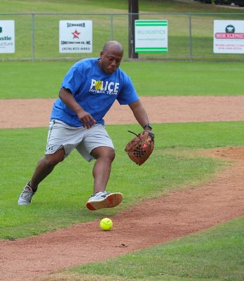 BPD’s Kevin Bellville leaps off the mound to spring on a ground ball during a game at the annual Guns N’ Hoses Softball Tournament last weekend at the Bellville Little League fields. (Cole McNanna/Sealy News)