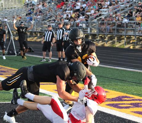 Sealy’s Connor Krenek finishes his block while Haden Wernecke delivers a stiff arm to a Columbus defender while falling into the end zone for a touchdown during the Tigers’ scrimmage against the Cardinals at T.J. Mills Stadium last Thursday. COLE MCNANNA