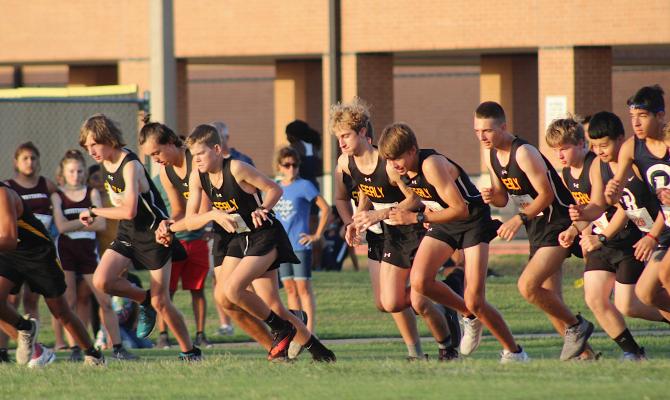 The Tigers explode off the finish line to embark on the JV boys' race during the Frio Friday Night Lights meet at Sealy High School last Friday. COLE McNANNA