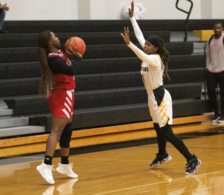 Lady Tiger sophomore Taniah Coleman defends a pass attempt from El Campo’s Bradejah Bradshaw in the first half of District 24-4A action at Sealy High School Jan. 14. COLE MCNANNA