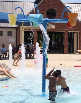 Pool-goers wait for the bucket of water to fall. COLE McNANNA