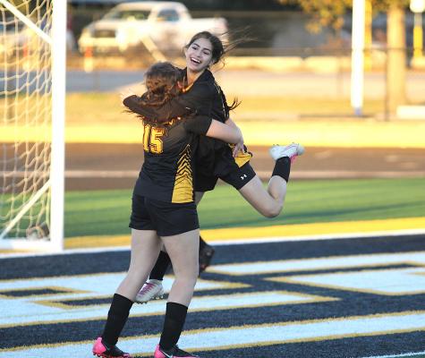 Sealy freshmen Jessica Picasso (15) and Dominique Castillo celebrate Castillo’s goal in the second half of the Lady Tigers’ district-opening match against Hempstead last Friday on Mark A. Chapman Field at T.J. Mills Stadium in Sealy. COLE McNANNA