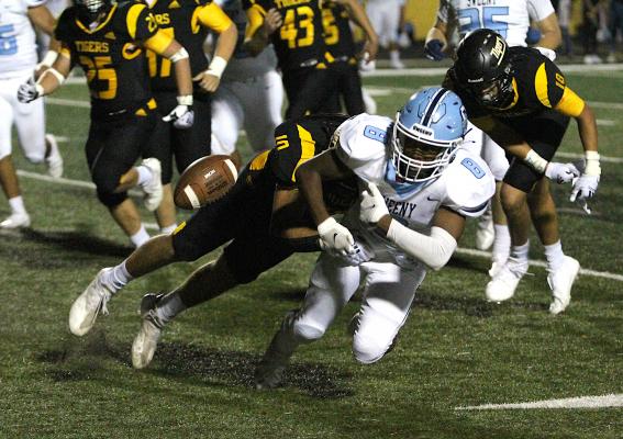 Sealy senior Thomas Clark forces a fumble on a carry from Sweeny’s Xavier Woods during the first half of the Tigers’ district game against the Bulldogs at T.J. Mills Stadium Oct. 22, 2021. Clark was an honorable mention linebacker on the TSWA All-State team. COLE McNANNA
