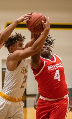 Sealy’s D’vonne Hmielewski and Bellville’s DJ Sanders battle for a rebound in the second half of the rivalry district game last Friday night at Sealy High School.