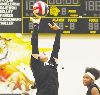 Blair Kram sets a ball for Jasmyne Joiner during the Sealy Lady Tigers’ scrimmage against Lexington at home Friday morning. COLE McNANNA