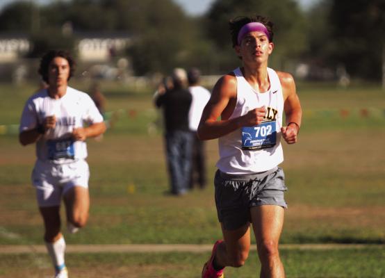 Sealy’s Gavin Almaguer leads the pack in the boys varsity cross country meet held last Monday at Sealy High School. Almaguer finished in first place to capture the boys’ varsity division district title. PHOTO BY ABENEZER YONAS