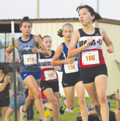 Brazos junior Esmeralda Garcia makes the turn during the Frio Friday Night Lights meet at Sealy High School Aug. 20. Garcia most recently was the individual winner in the varsity girls’ race at the Sealy Invitational last weekend. COLE McNANNA