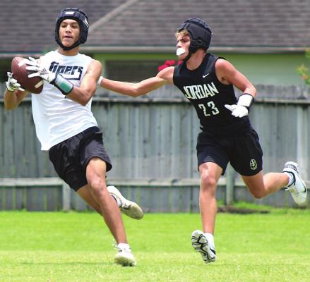 Tiger receiver Graham Samonte completes a catch and attempts to escape a Jordan defender during Sealy’s final 7-on-7 game at James E. Taylor High School in Katy Wednesday, June 30. PHOTOS BY COLE McNANNA