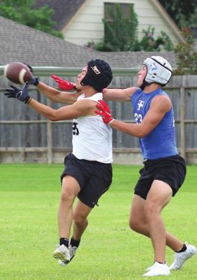 Tiger senior Julius Aguilar completes a contested catch during Sealy’s 7-on-7 game against Taylor in Katy Wednesday, June 30.