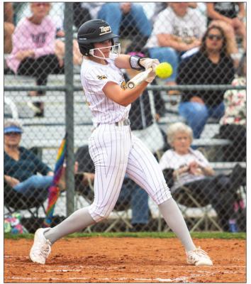 Sealy freshman Jaylyn Packebush connects on a pitch during the Lady Tigers’ districtopening game against Navasota March 14 at the Sealy High School Softball Stadium. PHOTOS BY COLE McNANNA