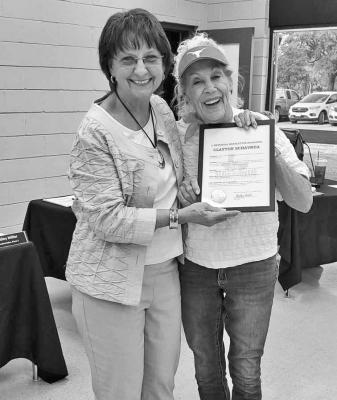 Sealy Mayor Carolyn Bilski is pictured with Chris Beckendorff with a proclamation honoring the contributions of Clayton Shavrda to the city of Sealy. KAREN LOPEZ