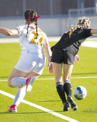 #22 sophomore forward Callie Whatley runs up field beating her marker in attempts to lay out a cross. PHOTO BY ABENEZER YONAS