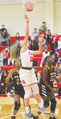 Bellville junior Neelie Schiel (13) hits a layup in the second quarter of the Brahmanettes’ district contest against the Sealy Lady Tigers last Friday night at home. Schiel later provided the game-winning layup with 8.8 seconds left. Photos by Cole McNanna