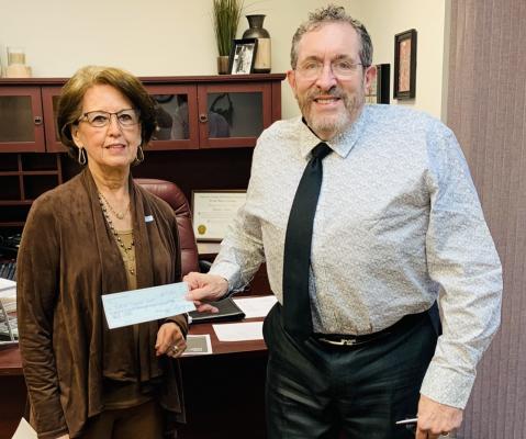 Marcella Schomburg, Chair of the Bellville Hospital Foundation, presents a check worth $221,498 to Bellville Medical Center CEO Daniel Bonk. CONTRIBUTED PHOTO