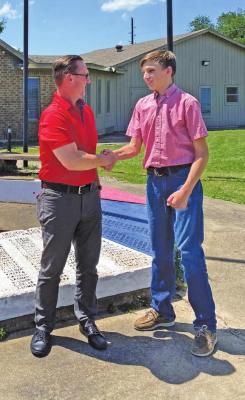 Brazos Independent School District Superintendent Scott Rogers congratulates Brazos High School student John Demny on being selected to attend the American Legion Boys State program this summer. RAE DRADY