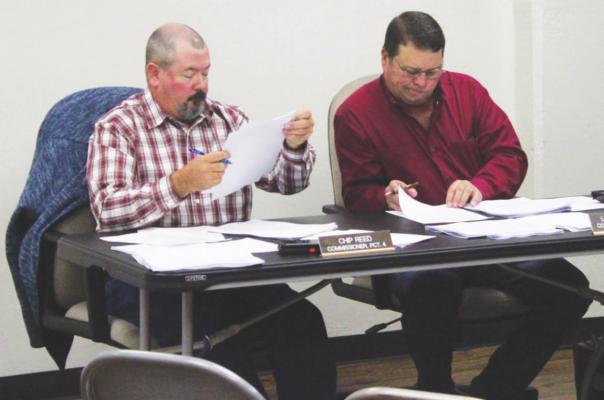 Commissioners Chip Reed and Leroy Cerny inspected the proposed changes to the voting districts. HANS LAMMEMAN
