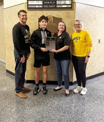 Pictured above is Gavin Almaguer with Head Cross Country Coach Danielle Eschenburg, Coach Val Eschenburg and Emma Reichardt.