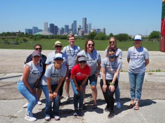 The American Foundation for Suicide Prevention (AFSP) hosted an Out of the Darkness Drive Through event in Houston back in April to help raise awareness about suicide. Pictured in the back row from left to right are Sandra Ramirez, Colleen Yankovic, Travis Wainscott, Terri Sudduth, Kimberlee Moayed and Donna Theriot. In the front row from left are Maria Cruz, Heather Lottering, Cammy Hazim, and Elizabeth Artemis. CONTRIBUTED PHOTO