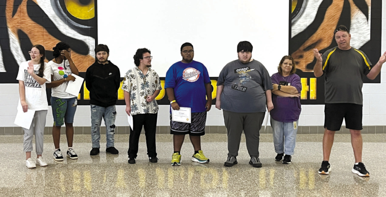 Sealy High School coach Casey Anderson congratulates students and participants on the unified track team on their performance this season, Wednesday, May 20, at Sealy Junior High School.