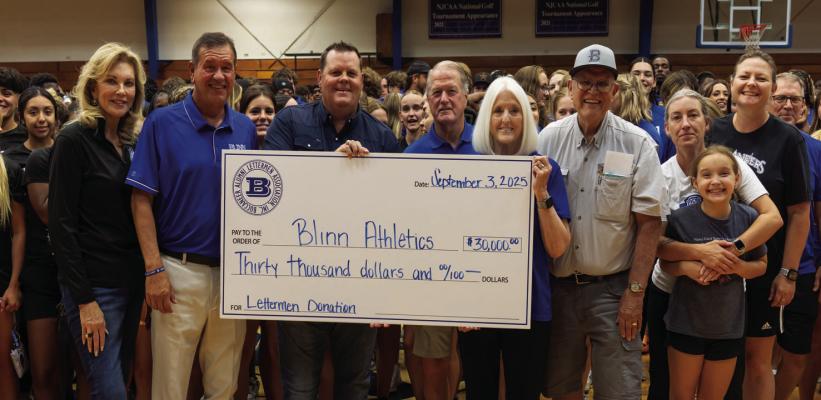 Buccaneer Alumni Lettermen Association President Kevin Bosse and Treasurer Gary Weiss present a donation of $30,000 to Blinn College District Chancellor Mary Hensley and Blinn athletic director Scott Schumacher on Wednesday, Sept, 3, in Brenham.