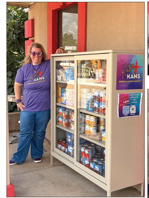 Kate Mize stands with a full food pantry at the Kate’s Kans Bellville location for the ribbon cutting ceremony, June 13. COURTESY PHOTOS