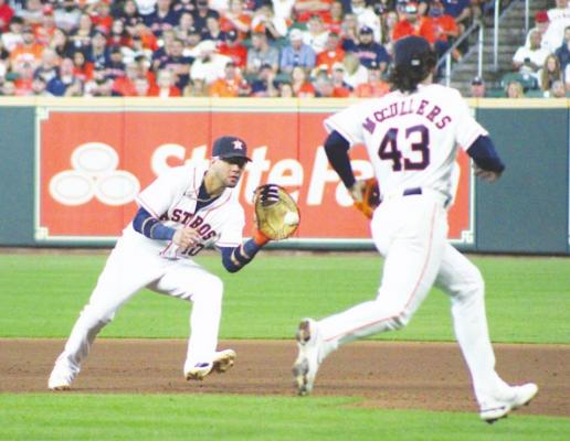 Houston first baseman Yuli Gurriel looks in a ground ball and prepares to feed starting pitcher Lance McCullers Jr. for an out during Game 1 of the ALDS against the Chicago White Sox at Minute Maid Park Oct. 7. COLE McNANNA