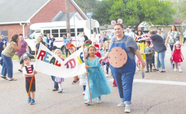 Luke Phillips and Avianna Darrow led their classmates in the annual Small World Book Parade behind Pre-K teacher Jennifer Palmer Nov. 3. HANS LAMMEMAN