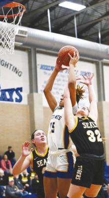 Sealy’s Kara Kram goes high for a rebound attempt during last week’s bi-district playoff loss to Bay City. Bay City was able to hold off Sealy 50-37 to advance to play Cuero this week. PHOTO BY JIMMY GALVAN